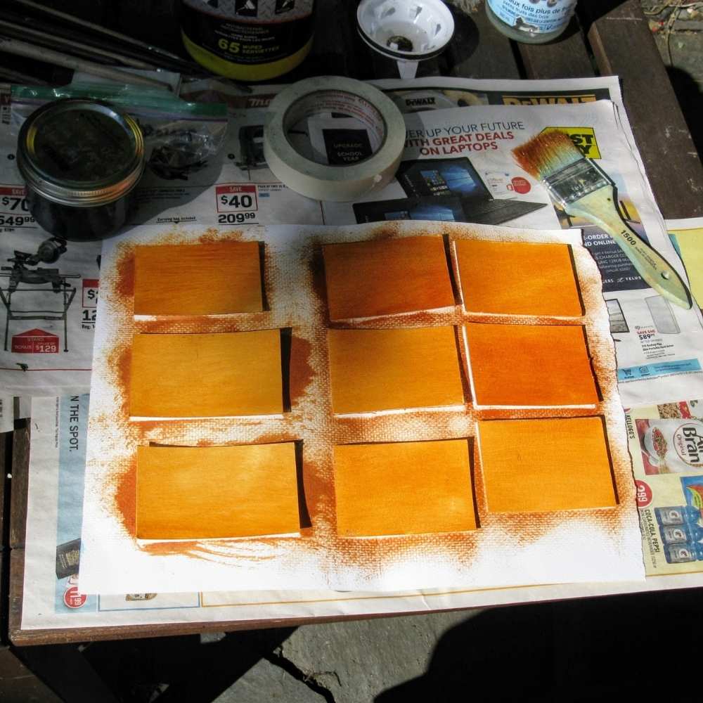 a bunch of small watercolor paper being toned for oil painting.